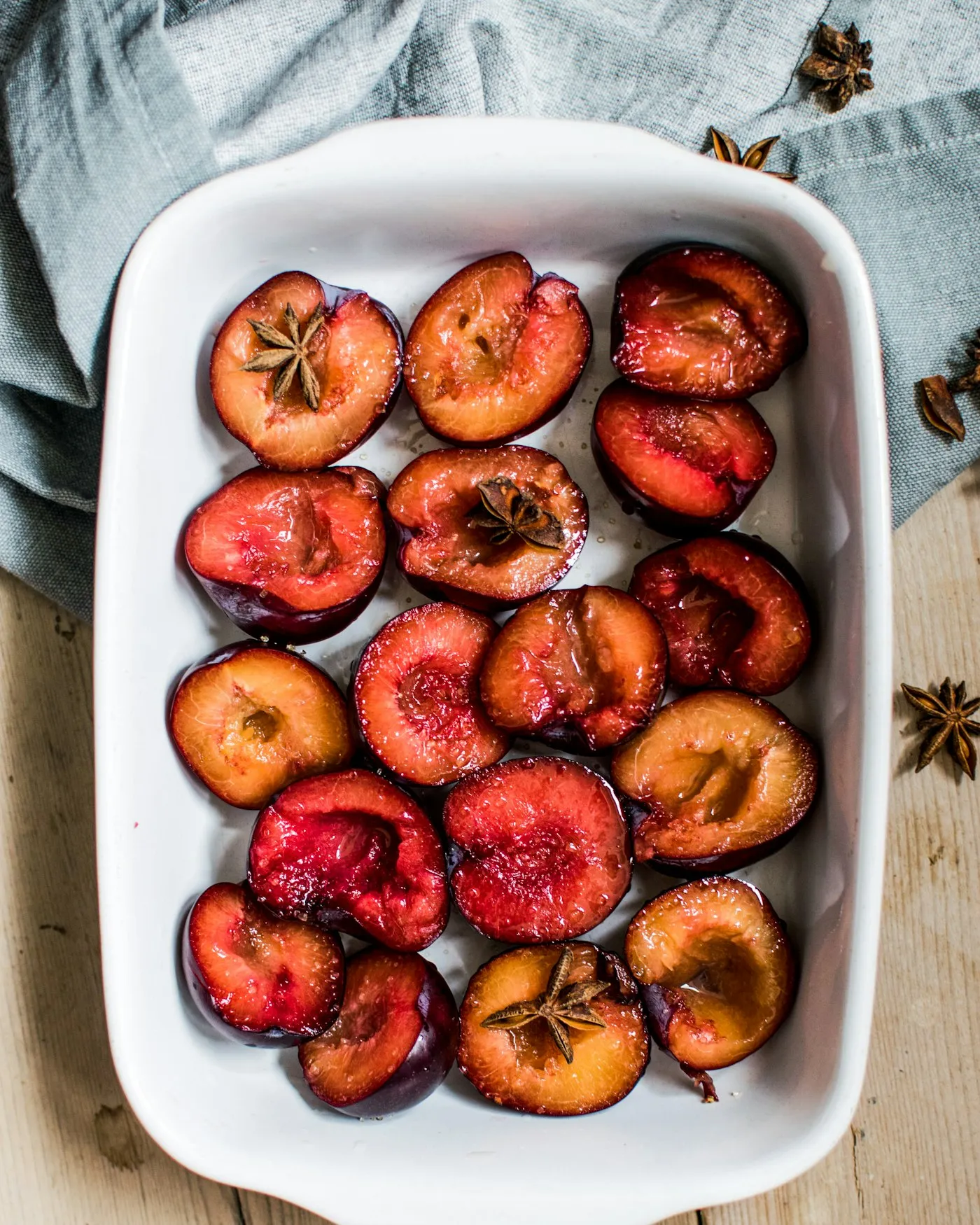 Slices of stone fruit arranged in a white ceramic tray