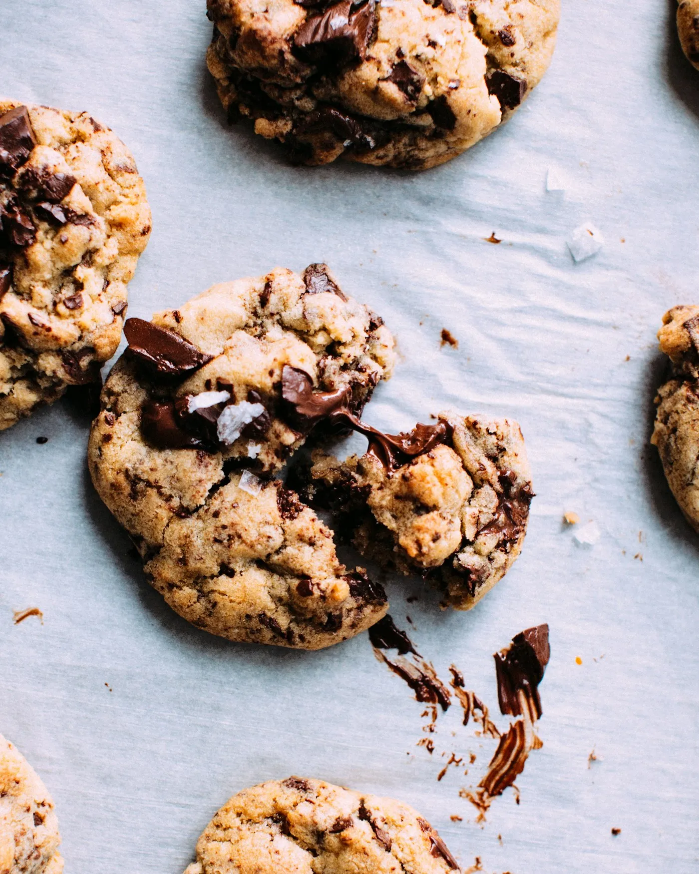 A close-up of baked cookies with visible pools of chocolate