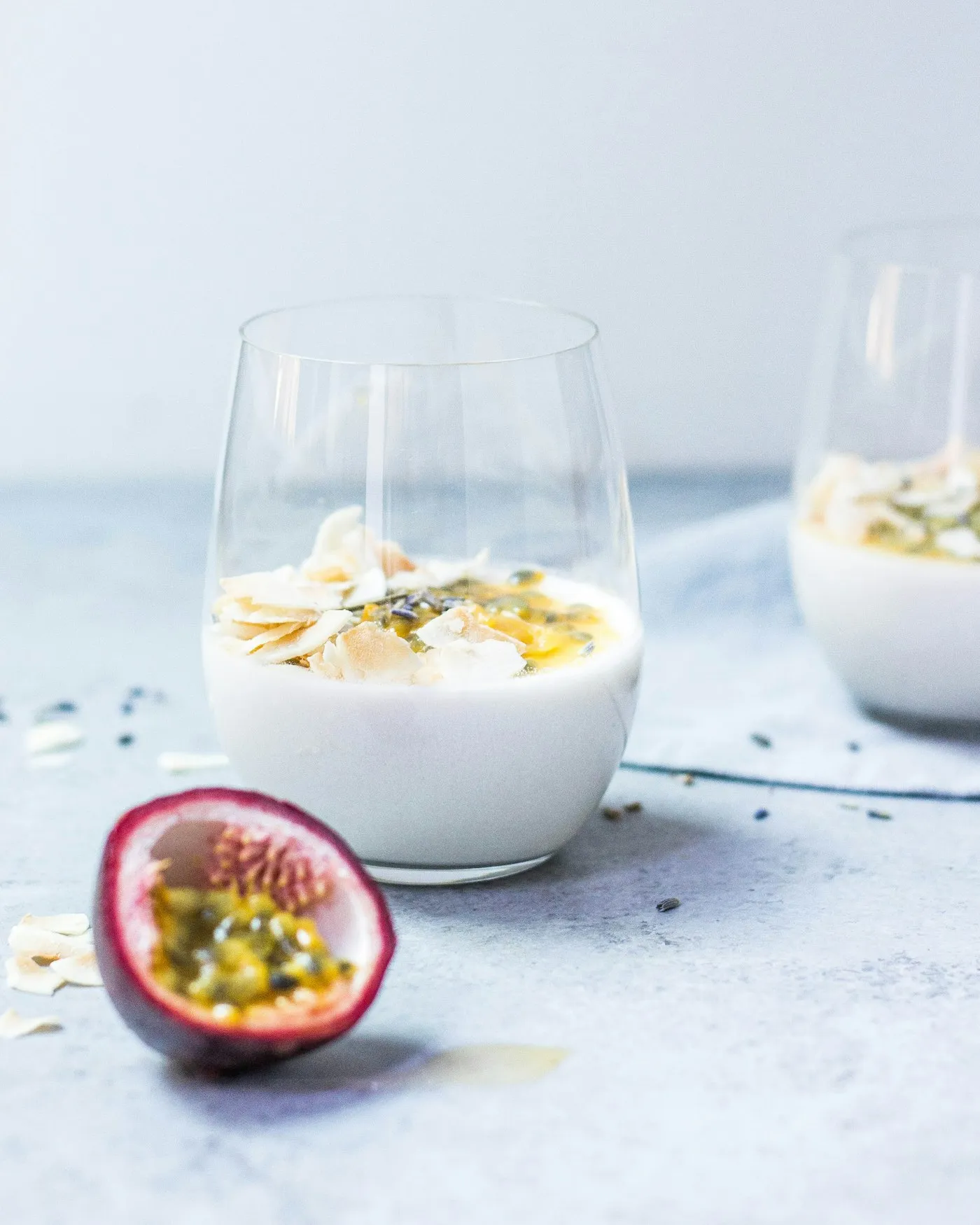 A clear glass cup filled with a set pale cream dessert